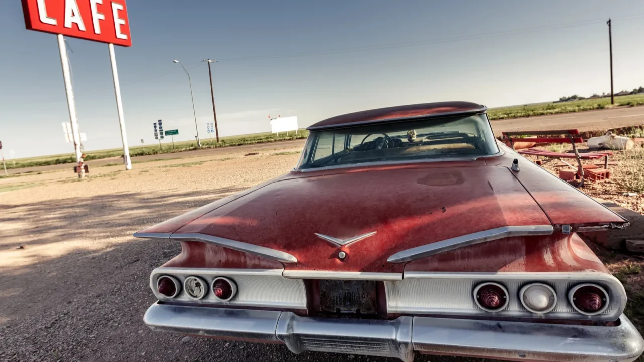 cafe sign and red retro car along route 66