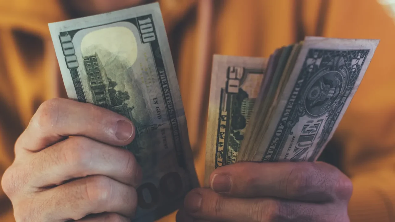 casual man is counting american dollar banknotes close up of