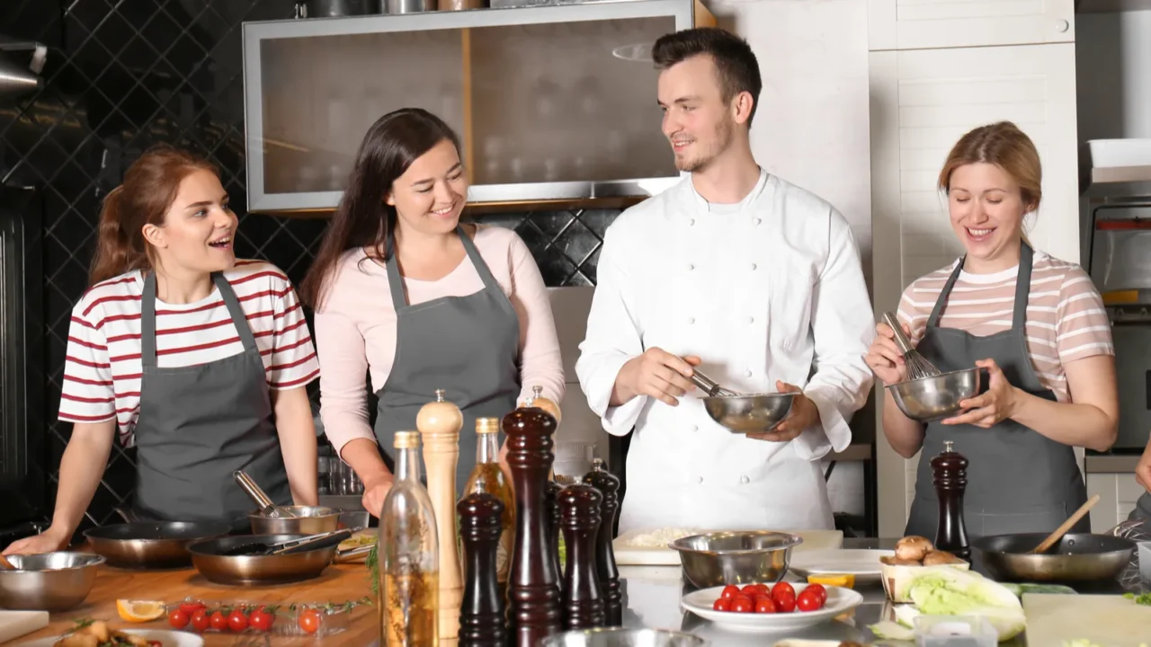 chef and group of young people during cooking classes