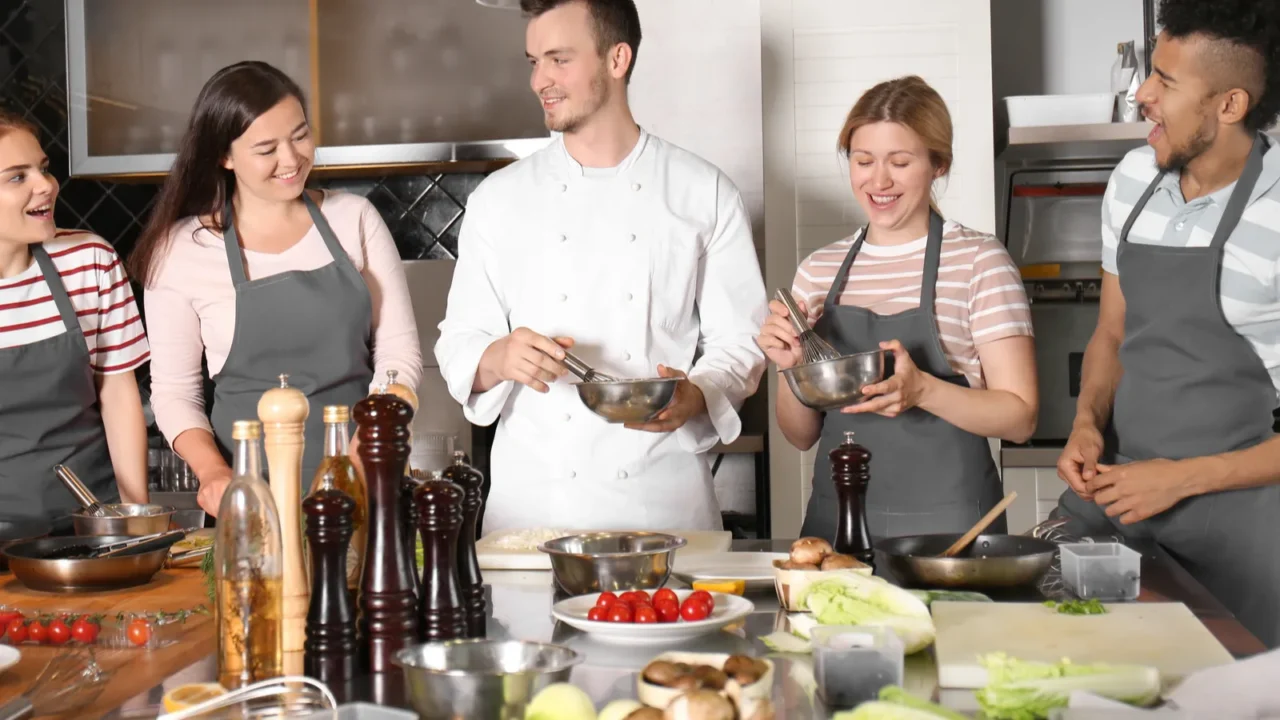 chef and group of young people during cooking classes