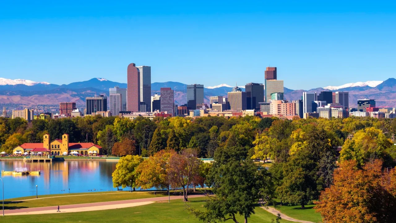city skyline of denver colorado downtown with snowy rocky mountains