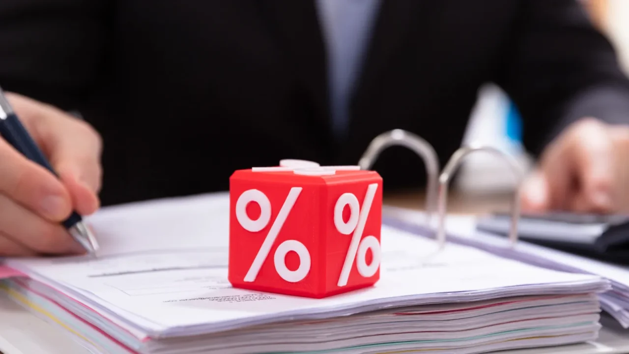 closeup of red cubic block with percentage symbol in front