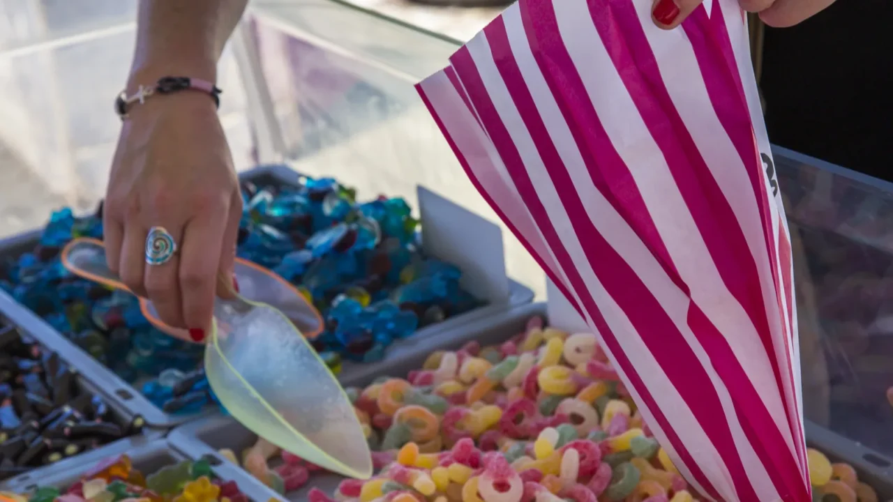 closeup of woman hand picking gummy sweets