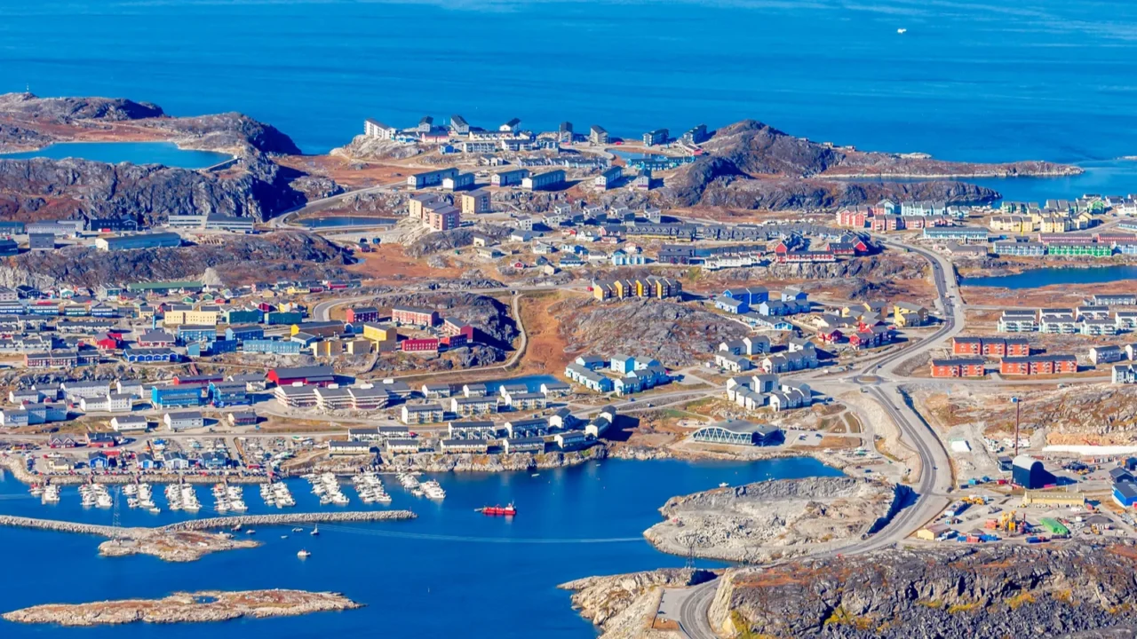 colorful arctic inuit houses at the fjord shore with marina