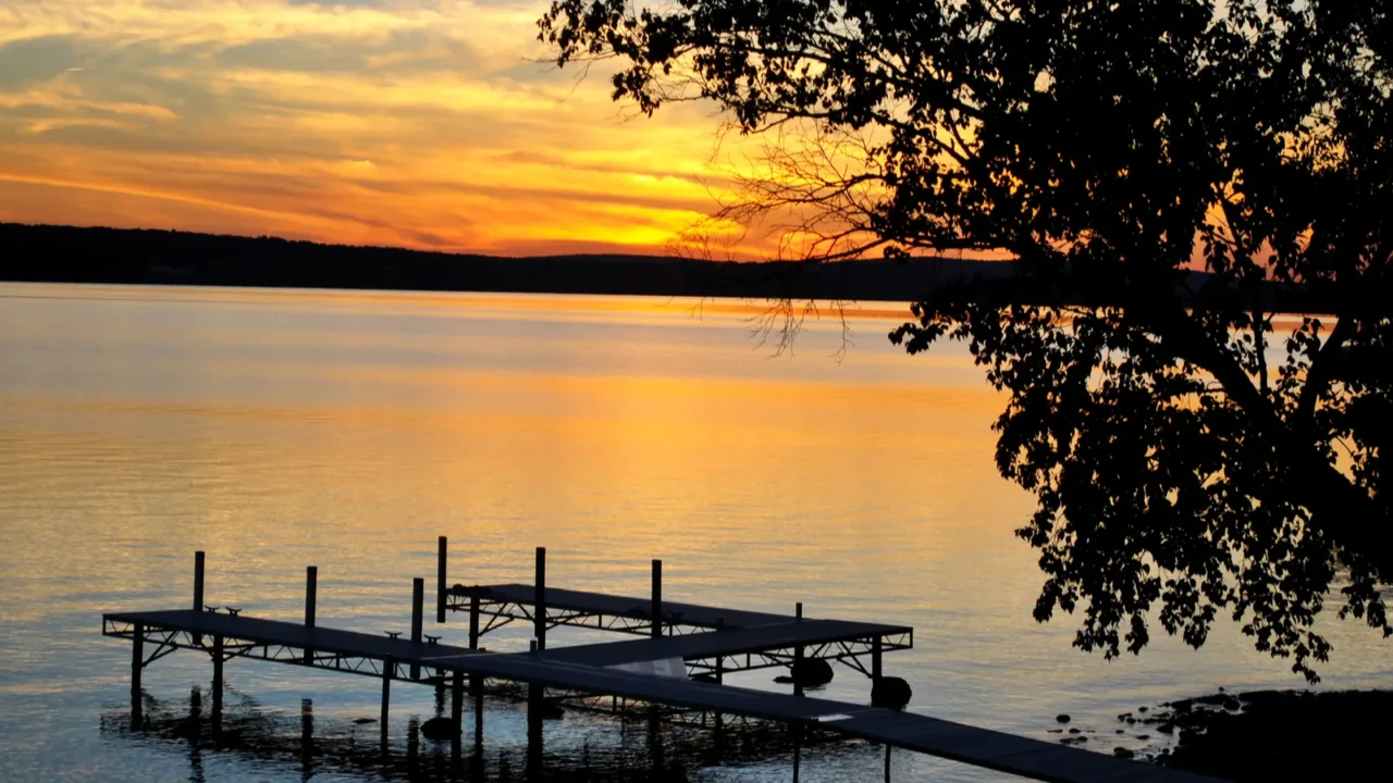 colorful summer sunset of a lake with a small boat