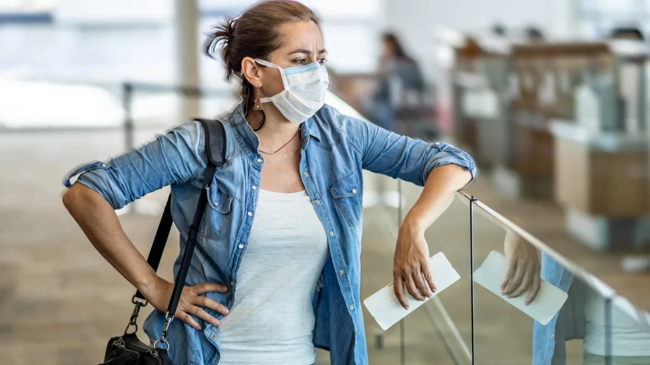 coronavirus outbreak travel restrictions travelers with face mask at international