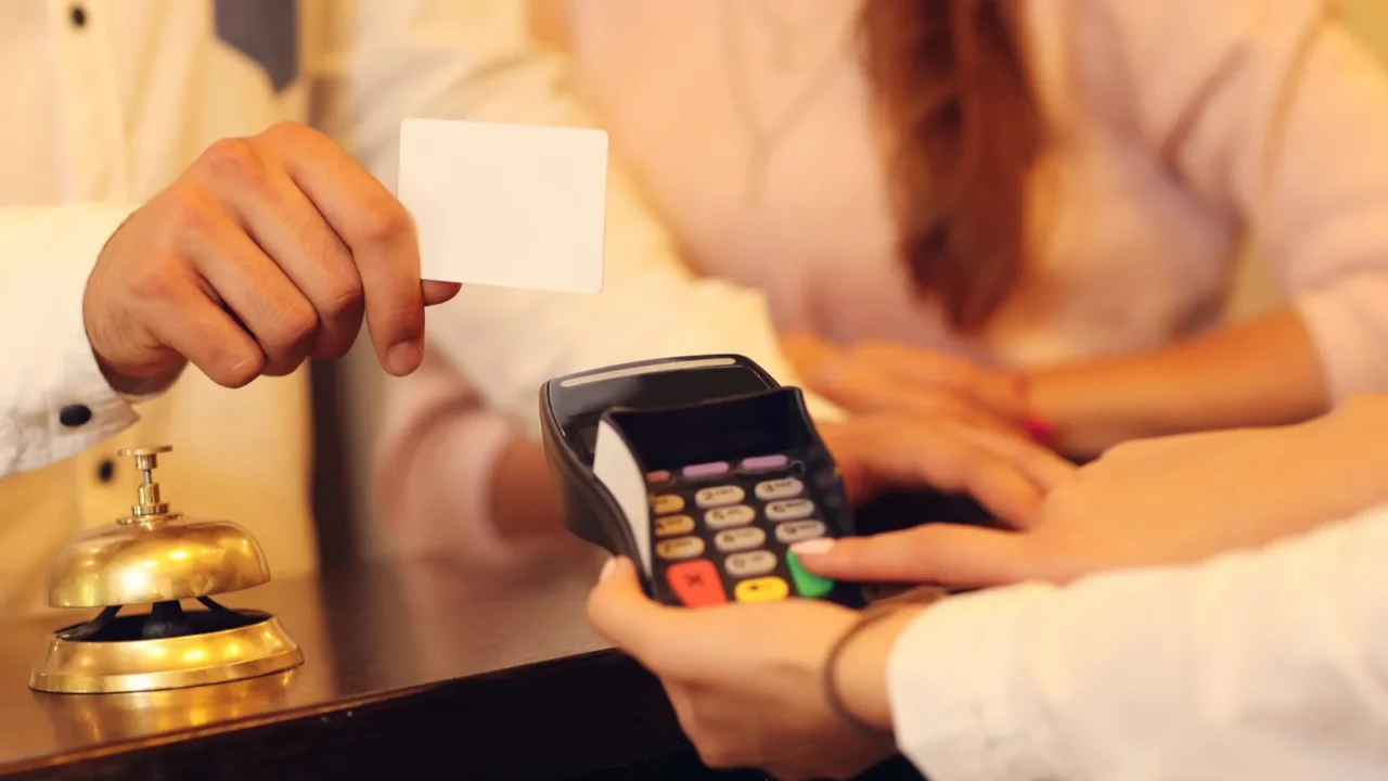 couple at counter paying for hotel