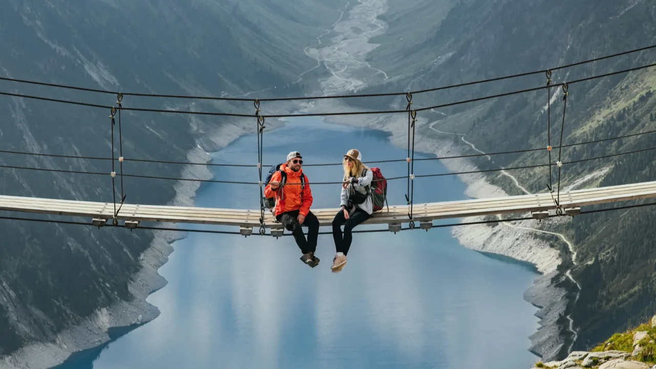 couple of travelers with a backpack in the mountains young