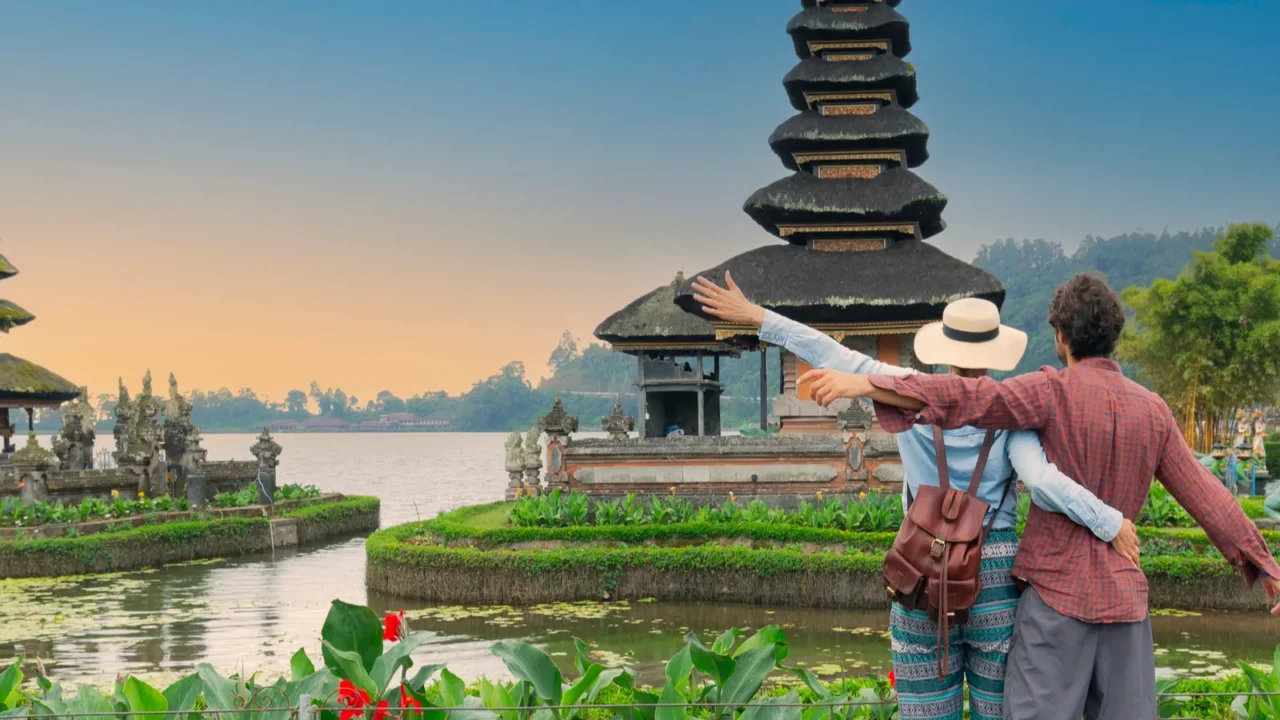 couple spending time at ulun datu bratan temple in bali