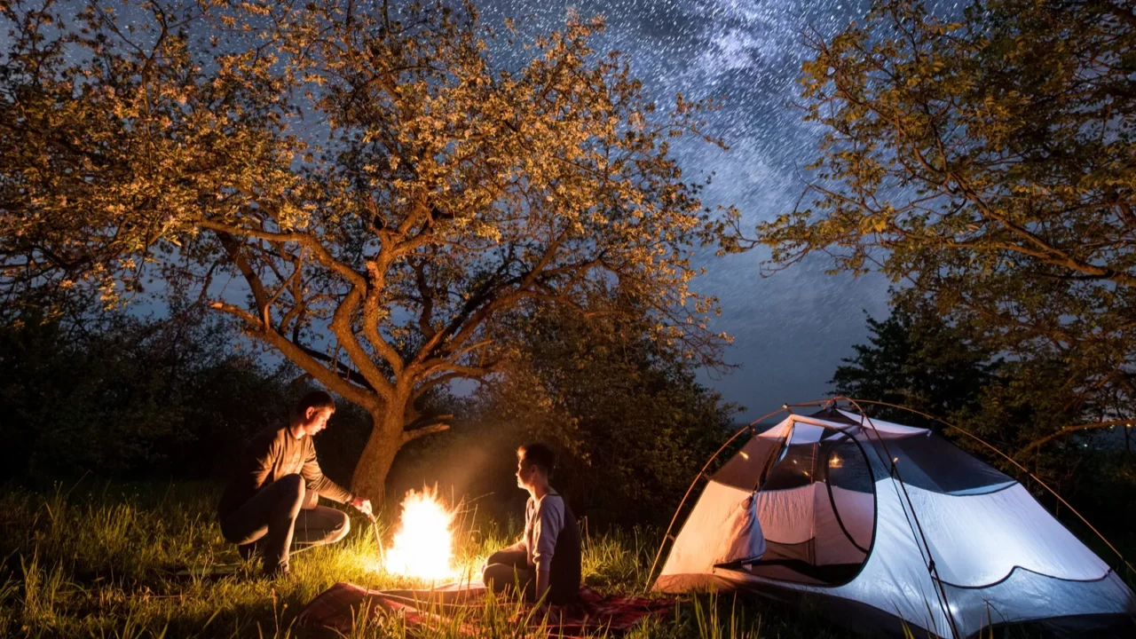 couple tourists at a campfire near tent