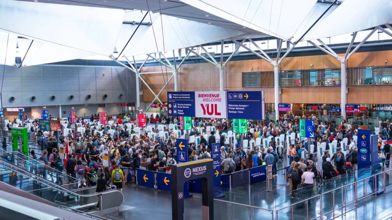 crowds of international passengers navigating immigration control at pierre elliott