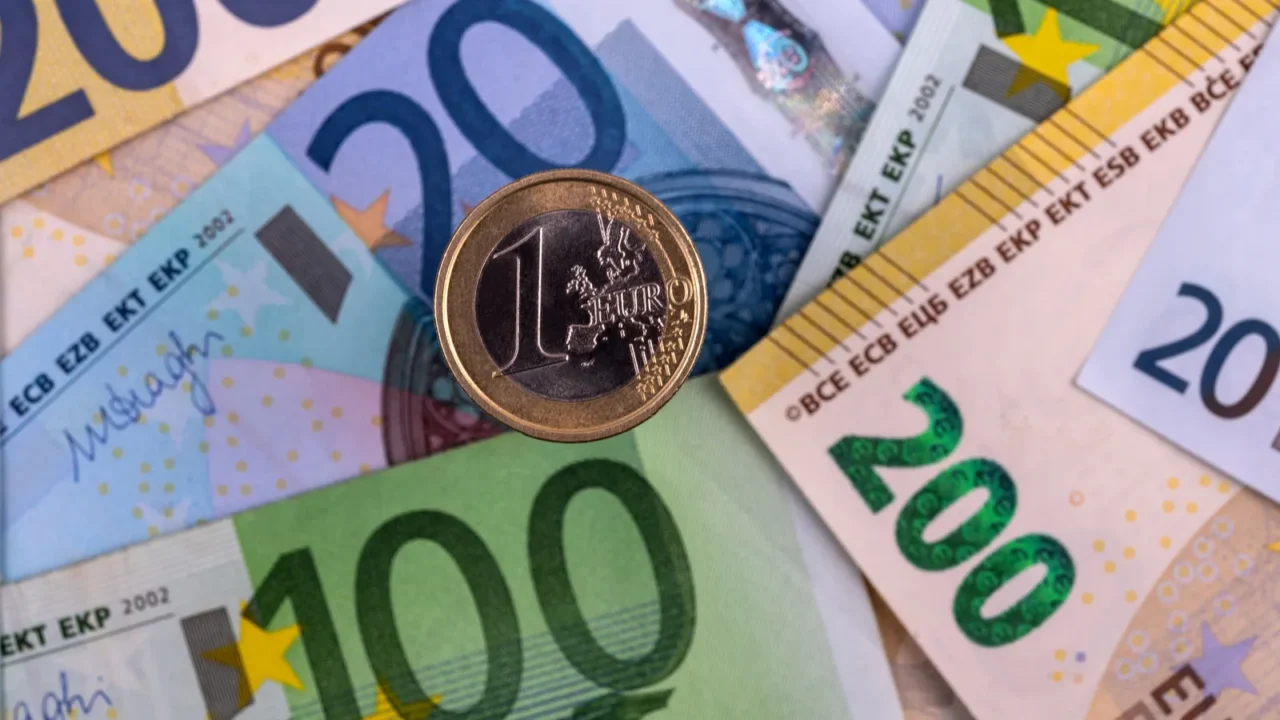 euro coin against the background of large european banknotes