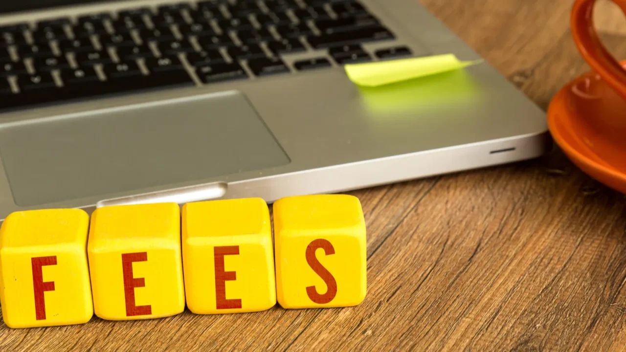 fees written on a wooden cubes