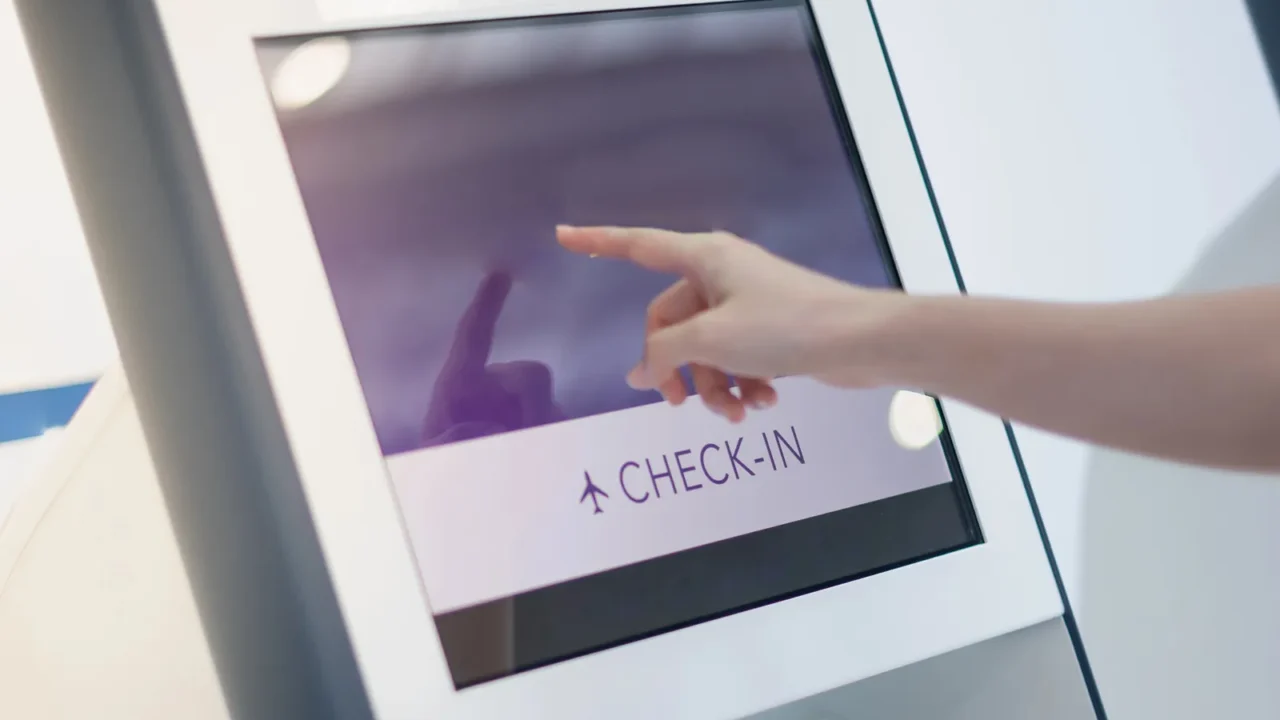 female hand using the auto self service checkin for get