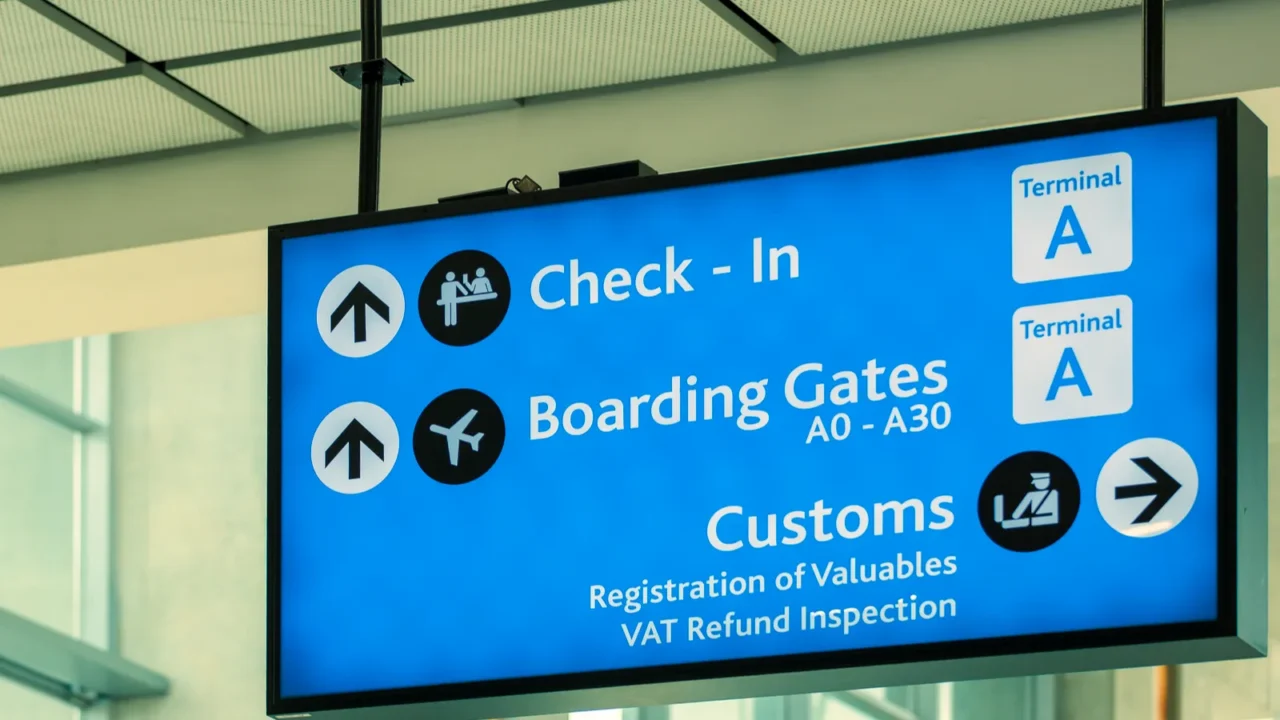 info sign at international airport  directions for check in