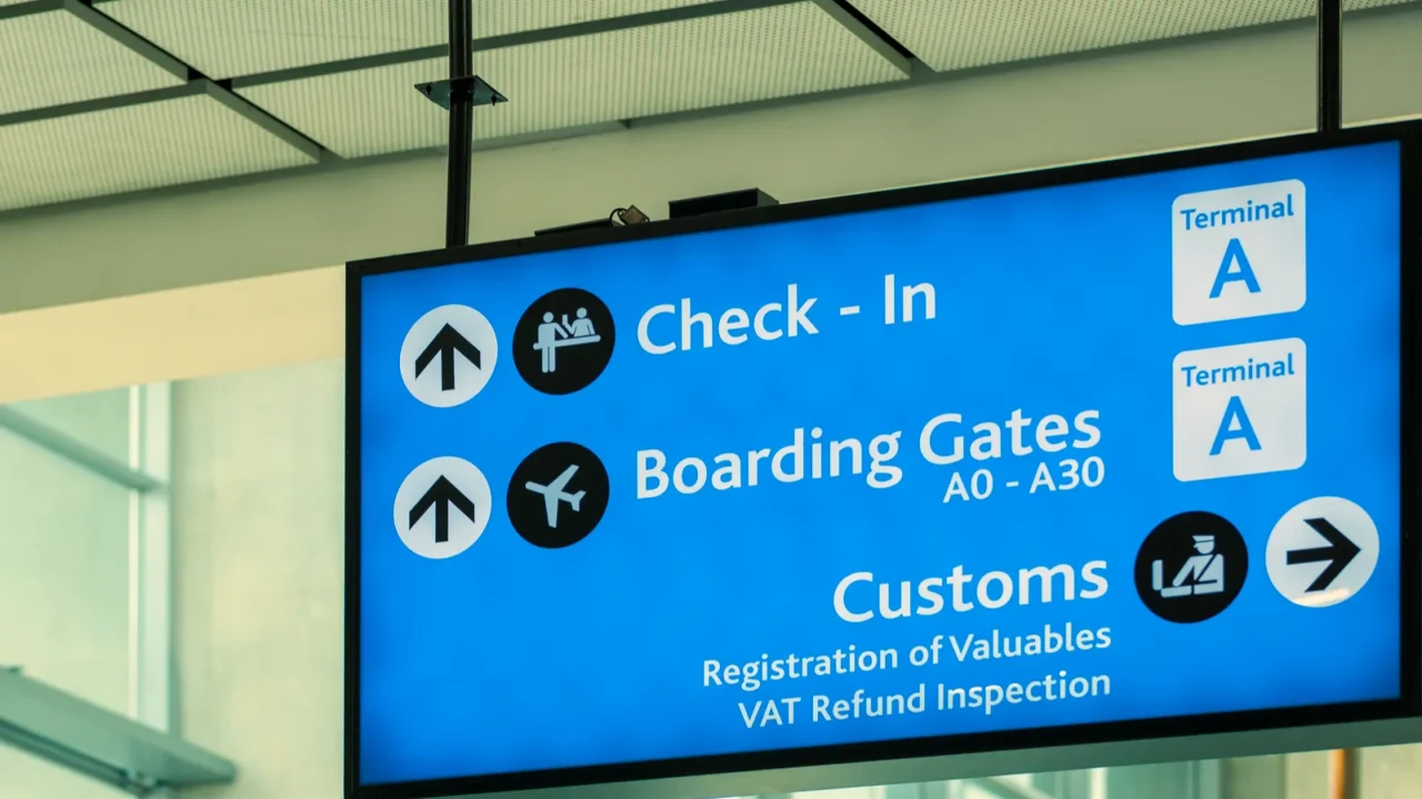 info sign at international airport  directions for check in