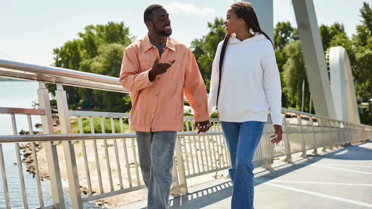 loving couple walks hand in hand sharing smiles while exploring