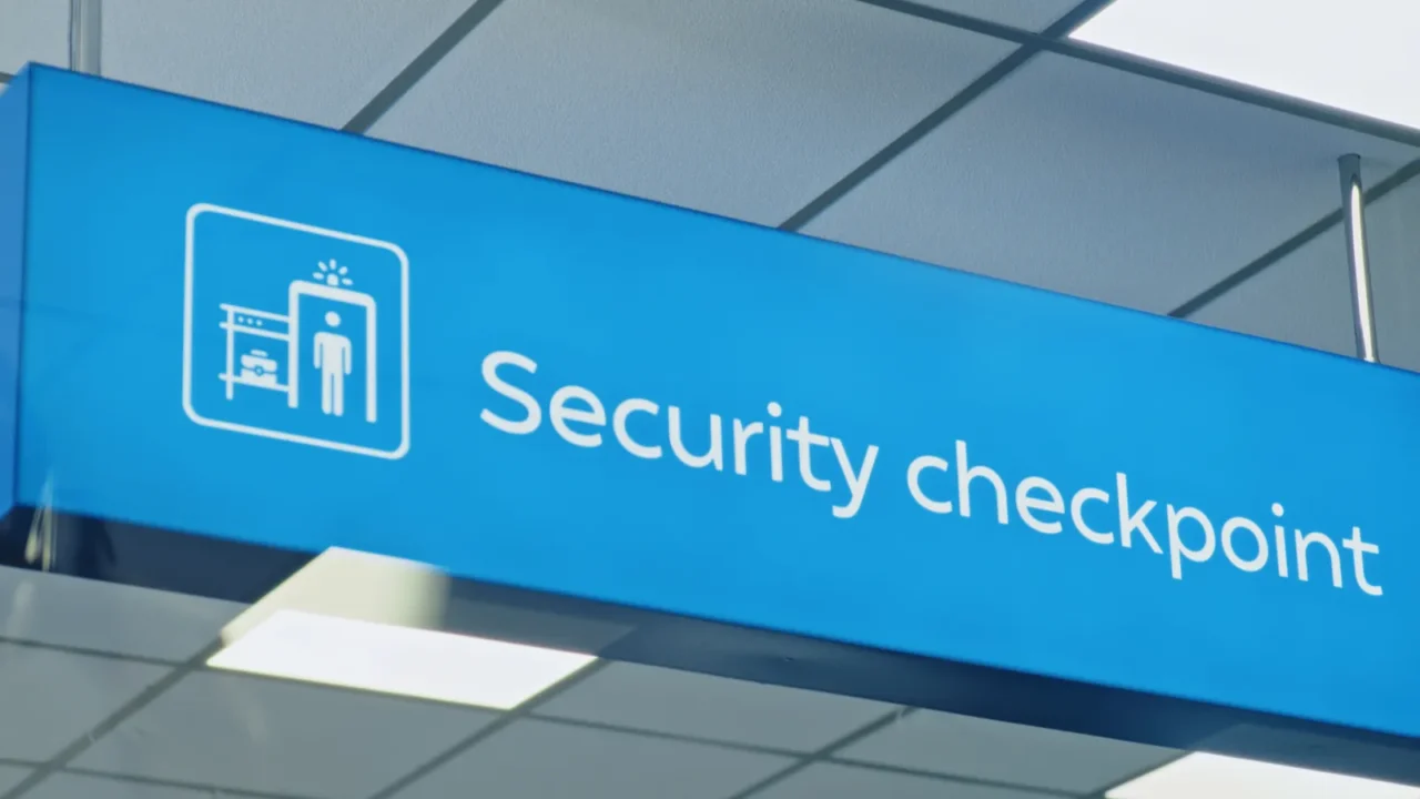 modern international airport terminal big led blue security checkpoint sign