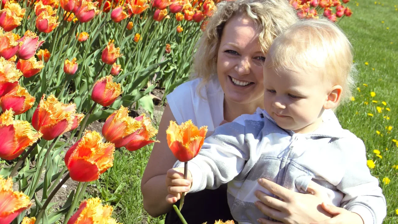 mother and child picking a flower
