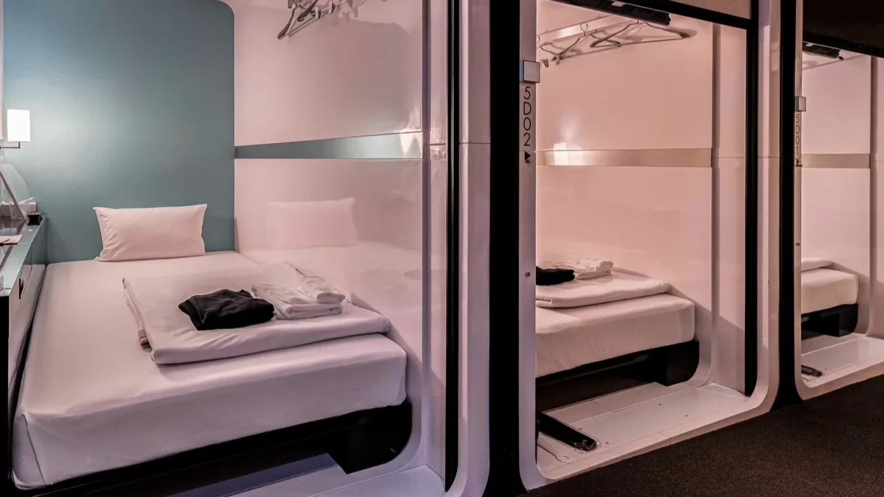 onestory bedroom area is combined inside a modern capsule hotel
