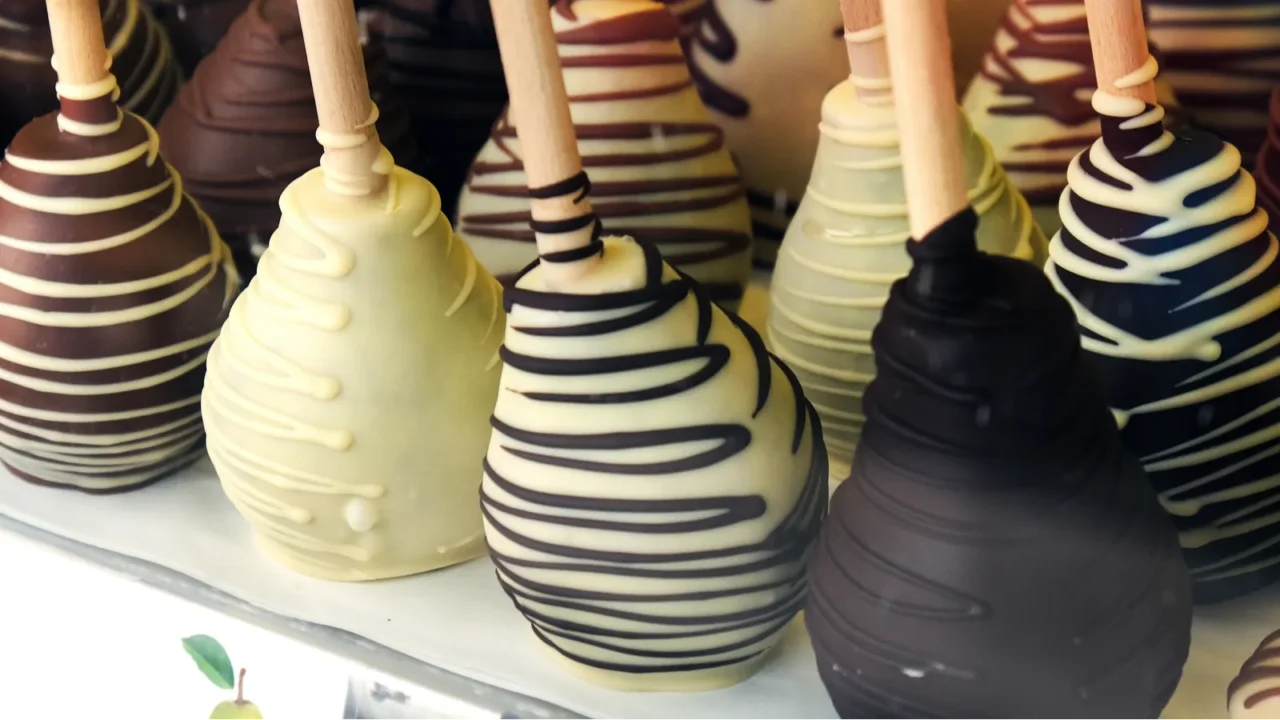 pears coated with black white and milk chocolate in candy