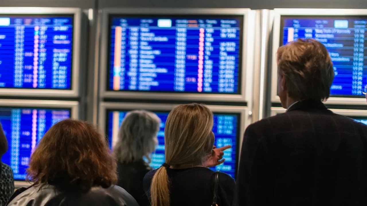 people waiting for flight at the airport back view