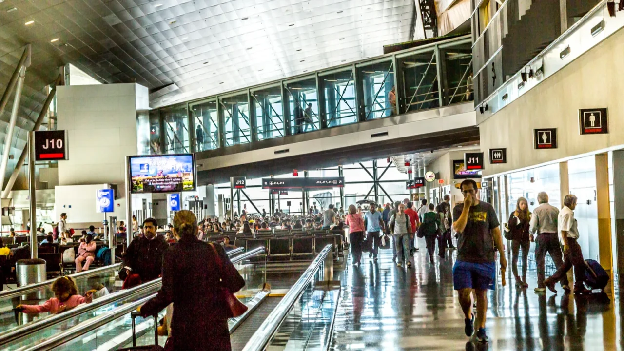 people with baggage on a moving staircase
