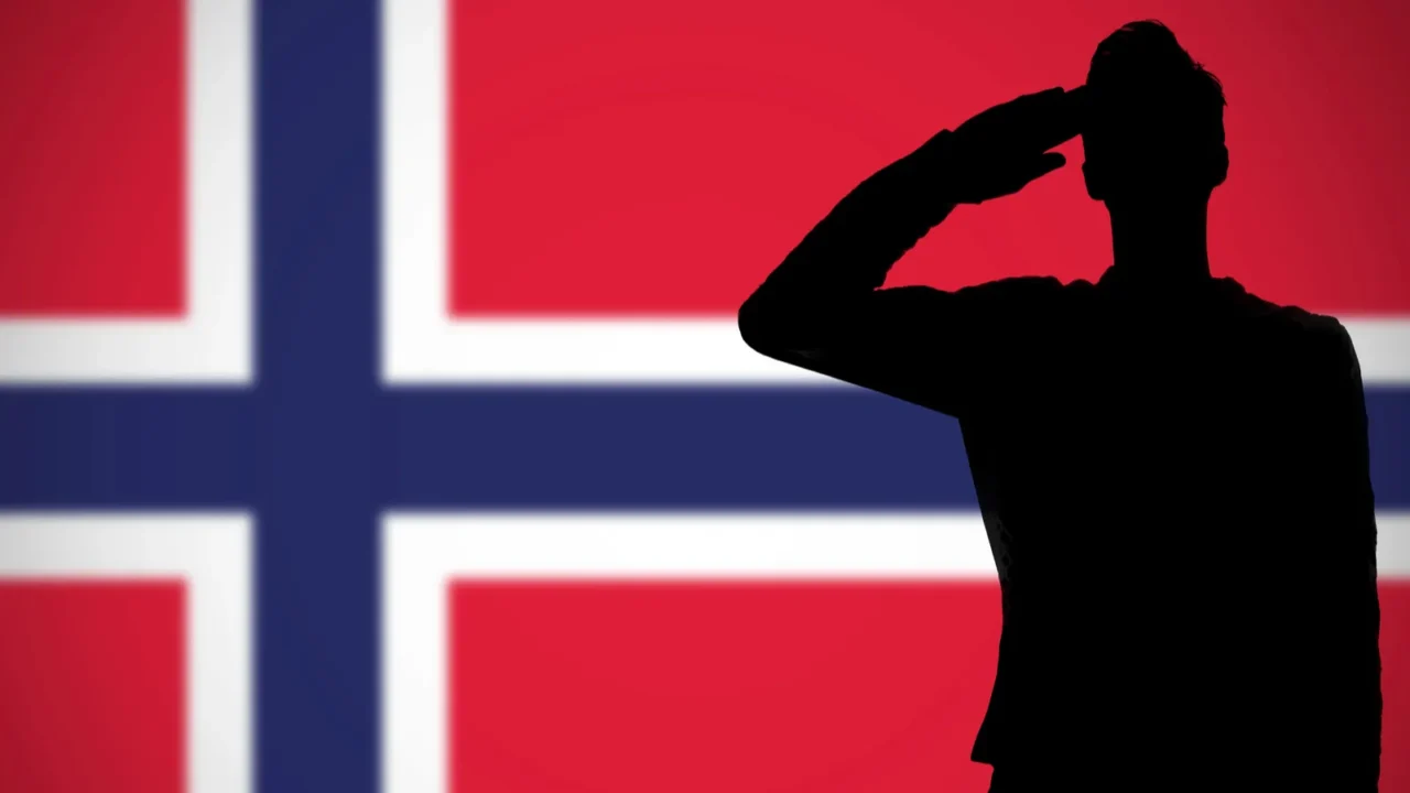 silhouette of a soldier saluting against the norway flag