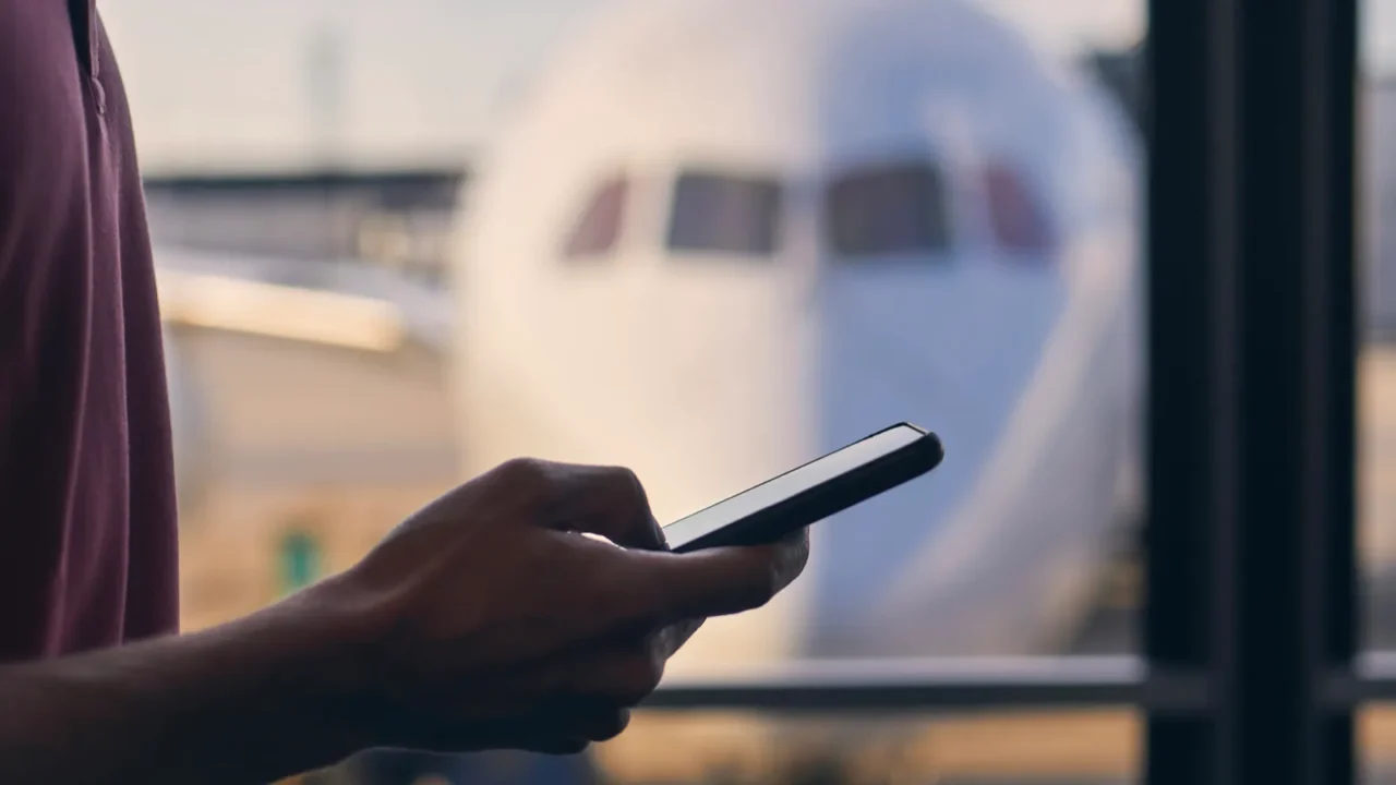 silhouette of hand of passenger while using mobile phone during