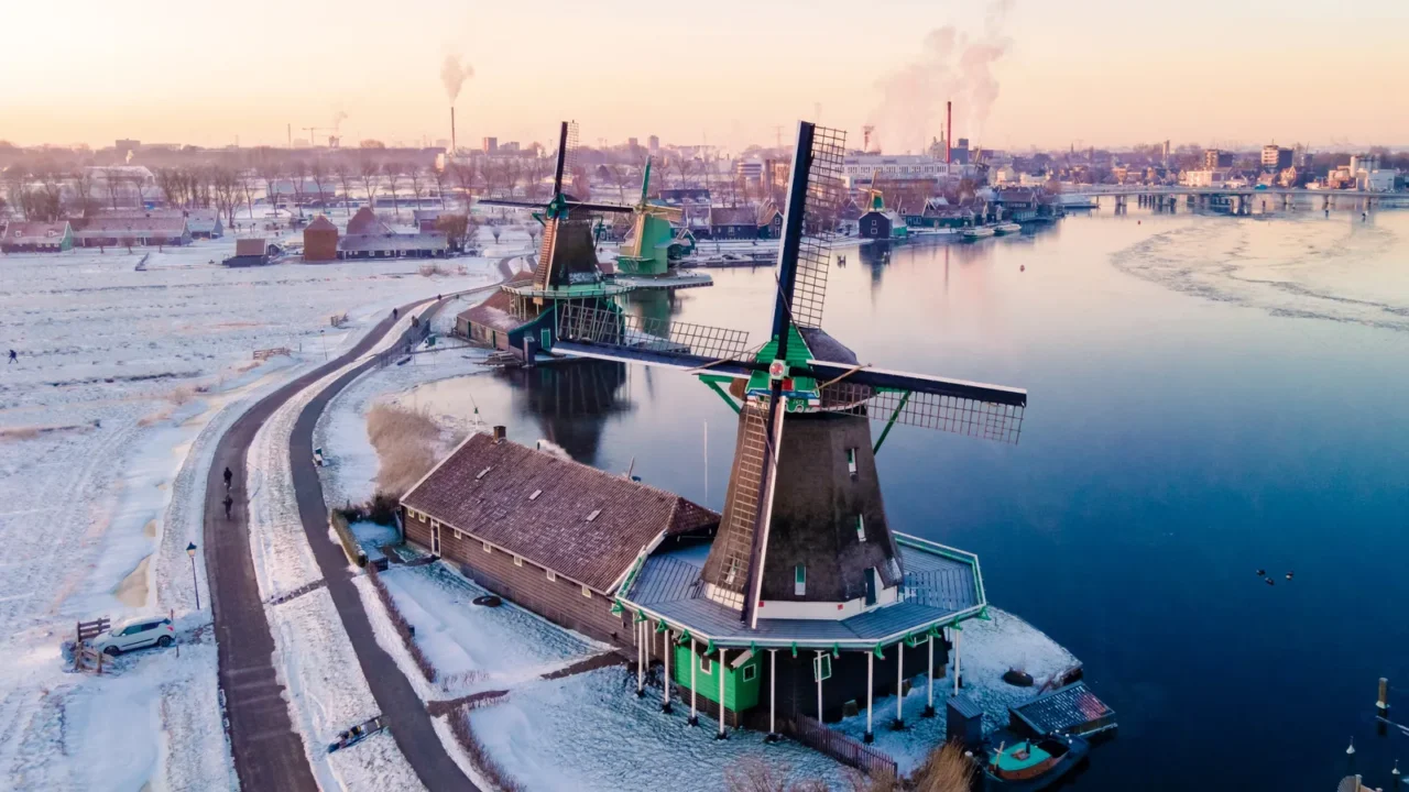 snow covered windmill village in the zaanse schans netherlands historical