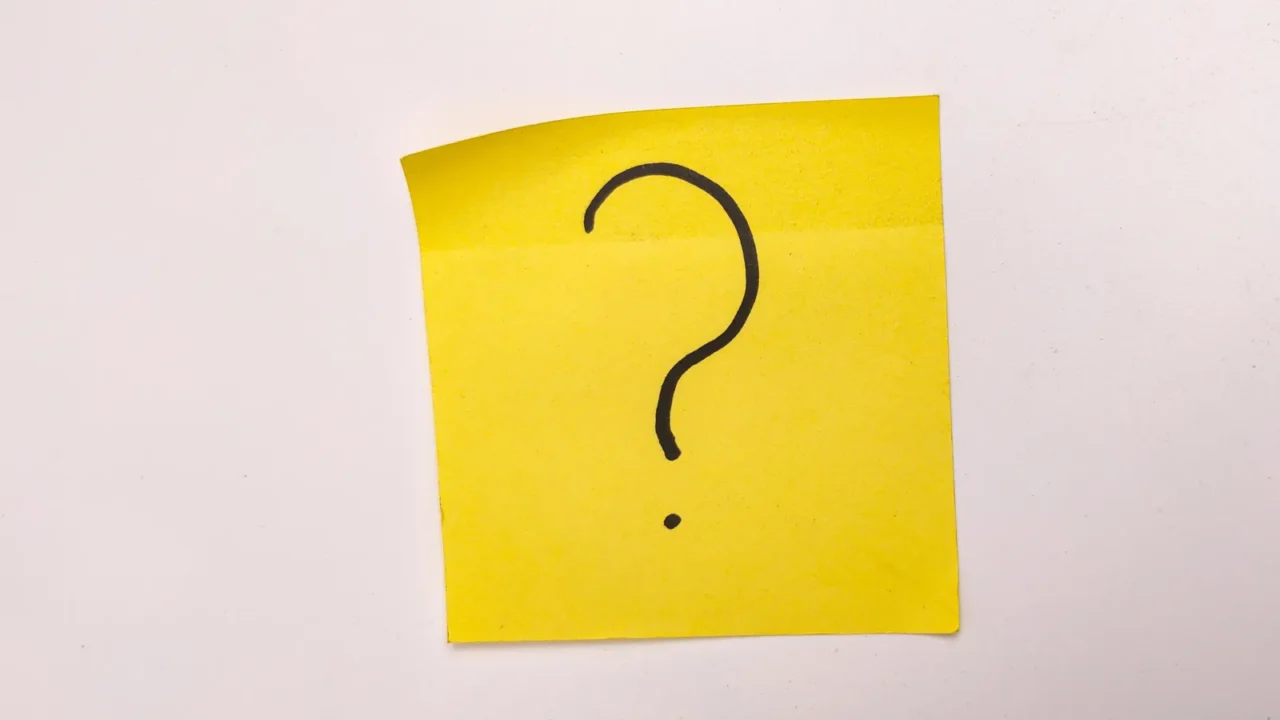 the image shows a yellow sticky note with a question