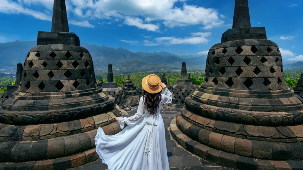 tourist visiting in ancient largest buddhist borobudur temple in java