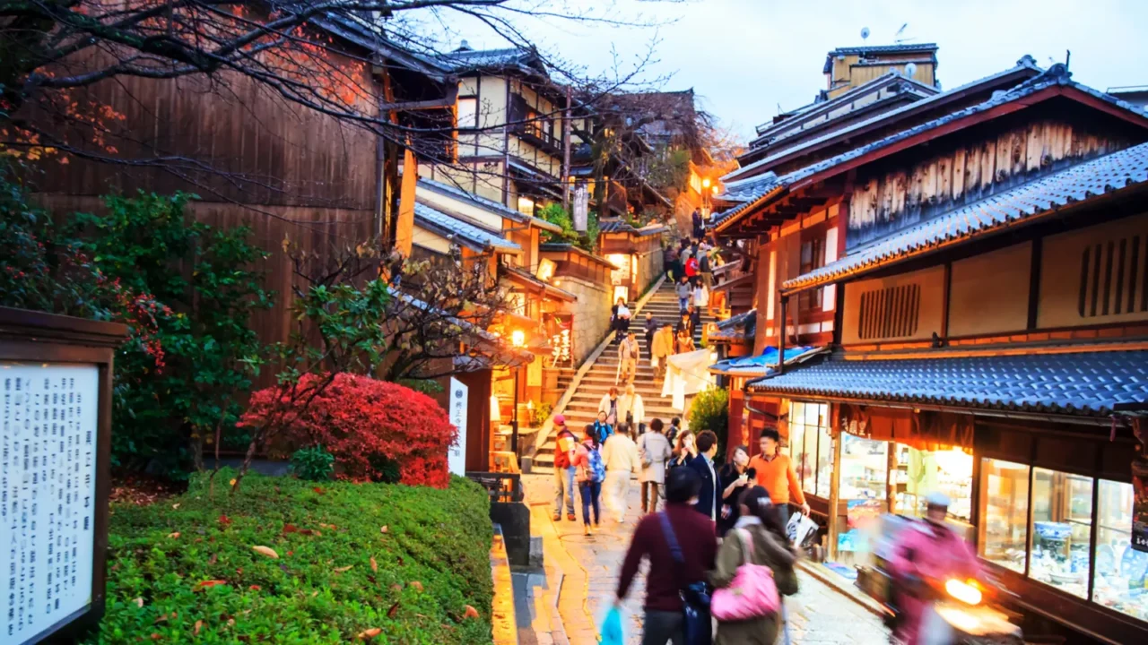 tourists walk on a street leading to kiyomizu temple