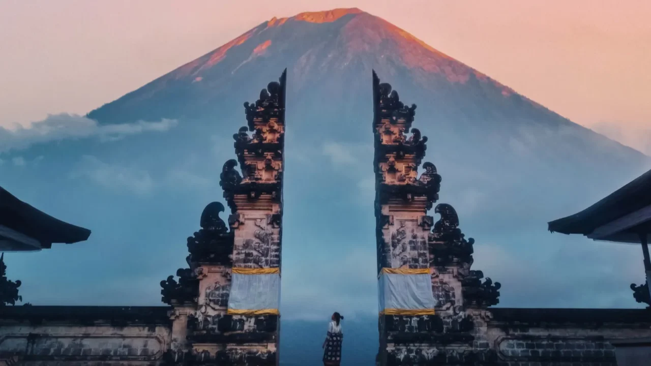 traveler standing at the gates of pura lempuyang temple aka