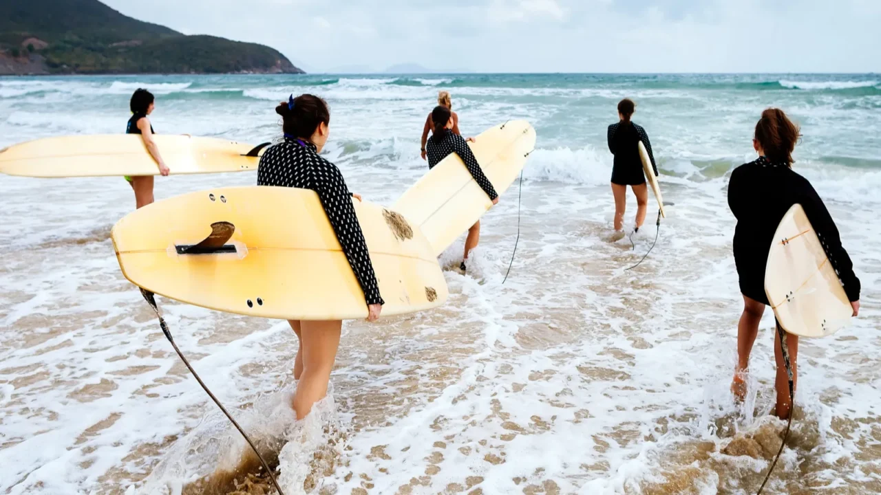 unidentified surfers with surfing boards