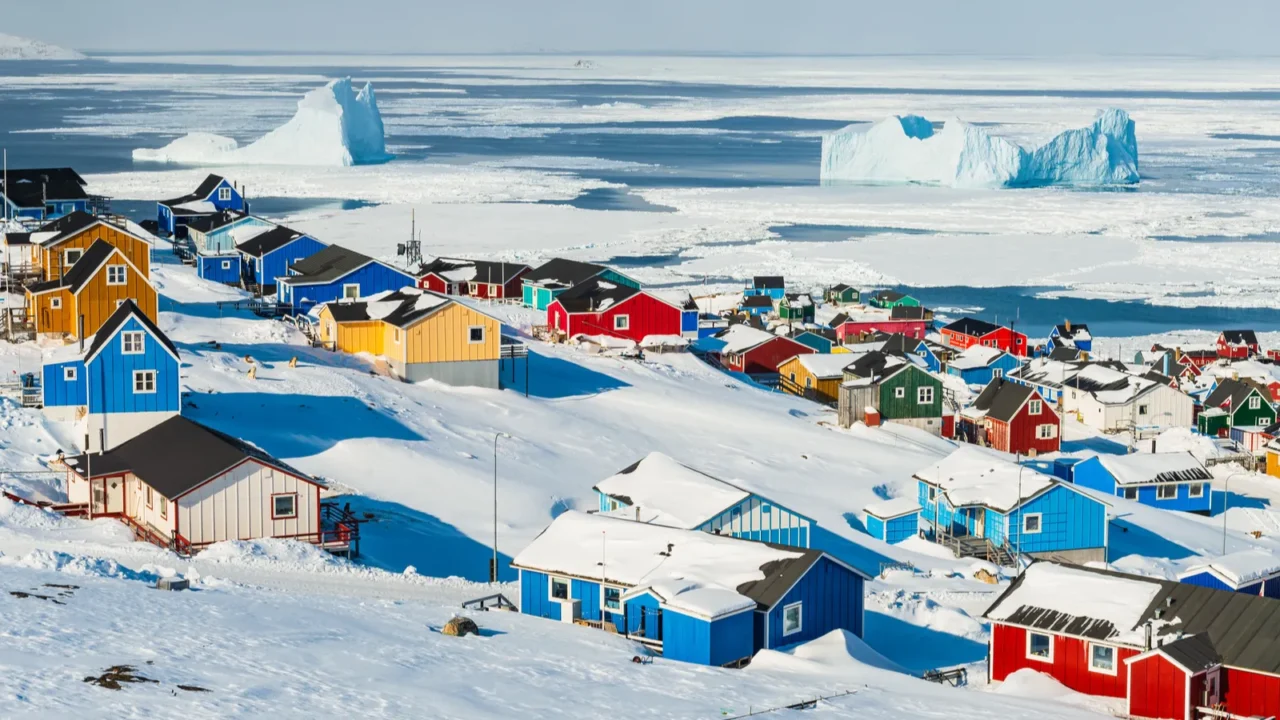 village overlooking sea with icebergs