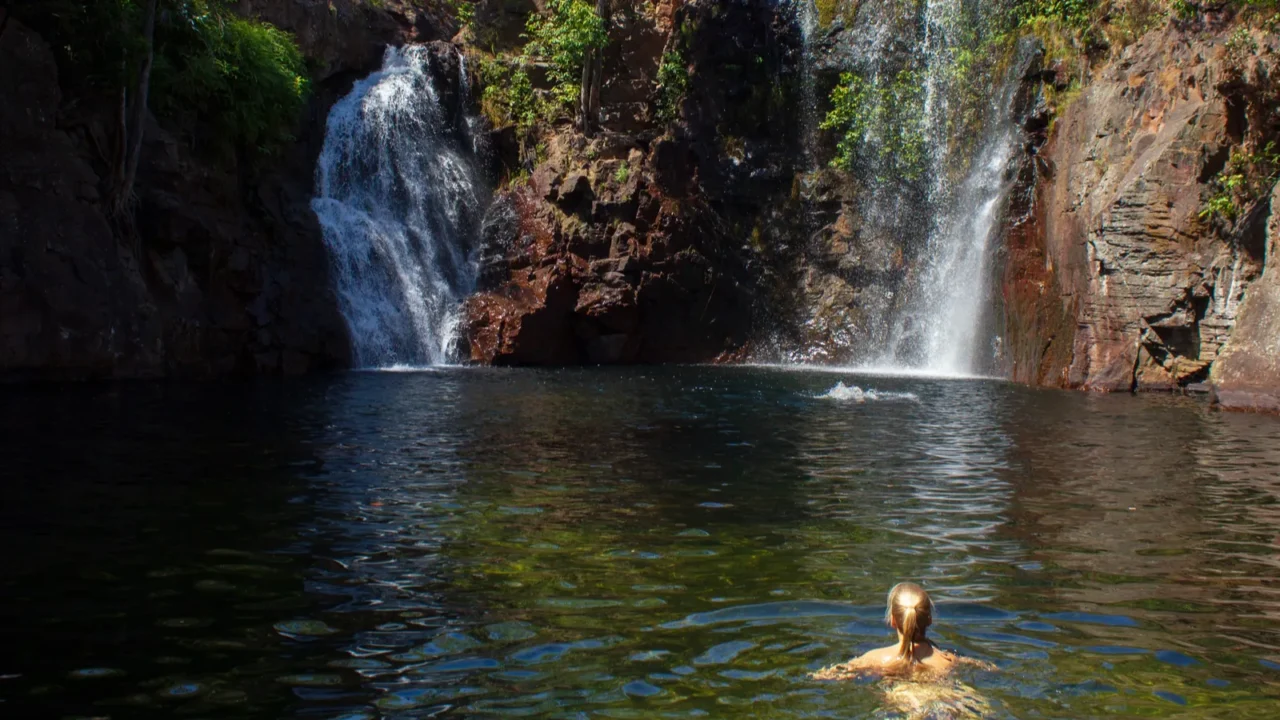youn girl enjoy srefreshing swim at florence falls very popular