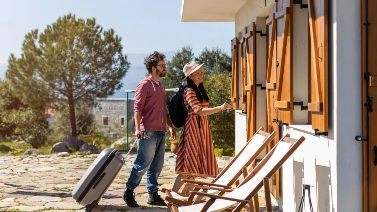 young couple arriving to at holiday home