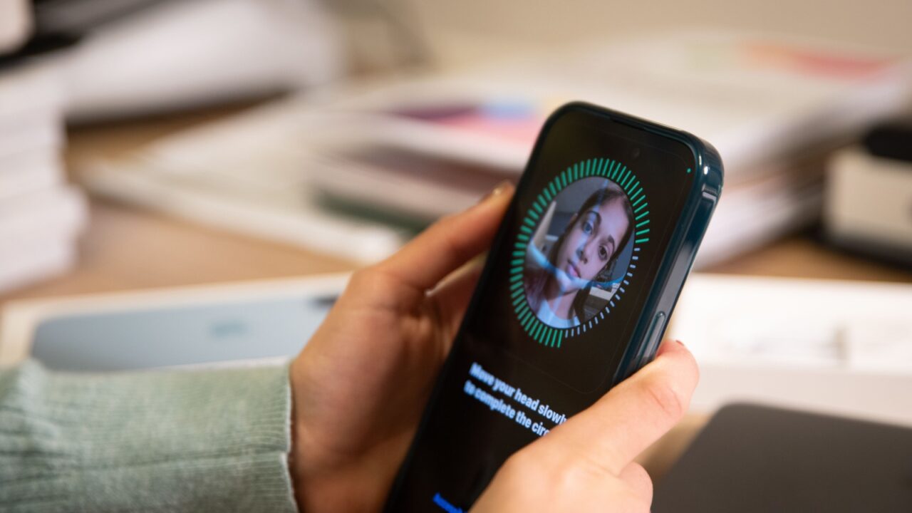 Leicester, UK. December 26 2024. A person holding an iPhone during the Face ID setup process, with the screen displaying the option to enable Face ID while wearing a mask.