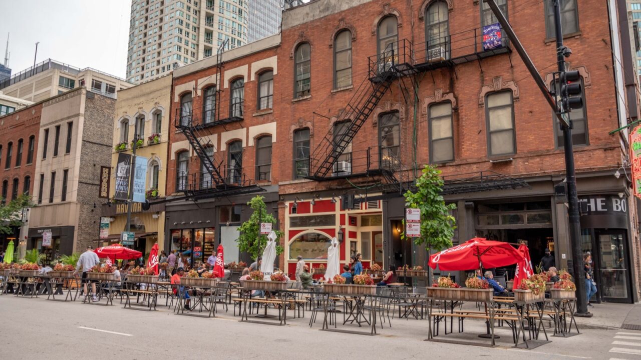 Chicago, IL - August 1, 2021: People dine out in the street on Clark, in River Downtown, in summer.