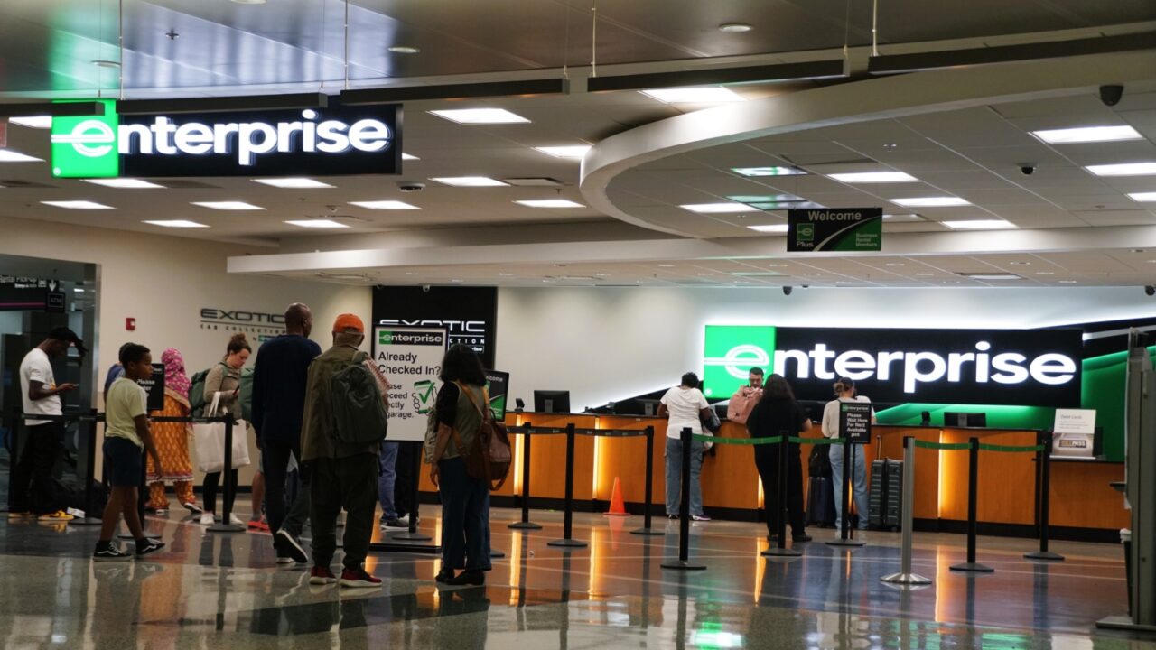 Miami, Florida, U.S.A - September 20, 2024 - Customers waiting in line to get their reservation at Enterprise Car Rental