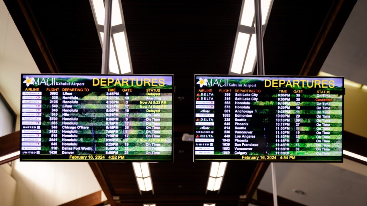 Kahului, Hawaii US - February 16, 2024: Airport flight information on a large screen boards at Kahului Airport (OGG)
