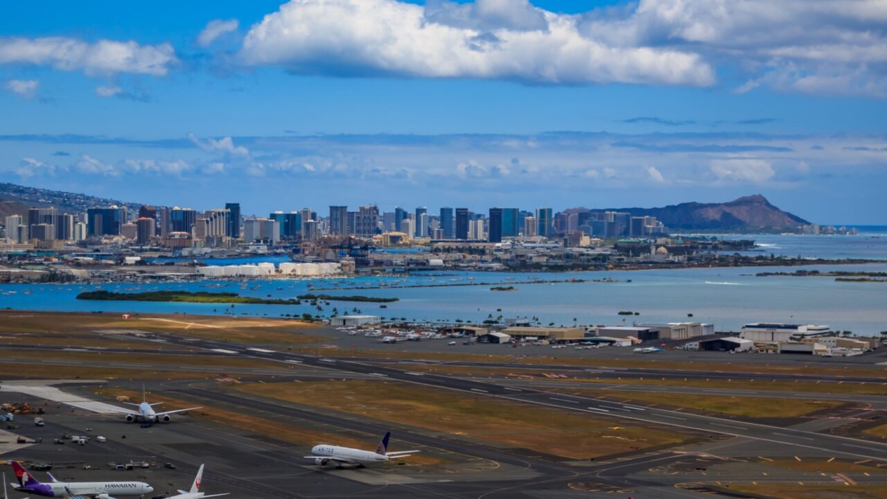 Honolulu, Hawaii, USA - May 25, 2015: Aerial view of downtown Honolulu, Diamond Head and airplanes on the field of Daniel K. Inouye International Airport (HNL), Honolulu International Airport