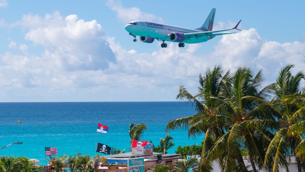 ST. MAARTEN - NOV. 28, 2023: Caribbean Airlines Boeing 737 Max 8 9Y-GUY flying over Maho Beach before landing on Princess Juliana International Airport SXM on Sint Maarten, Dutch Caribbean.