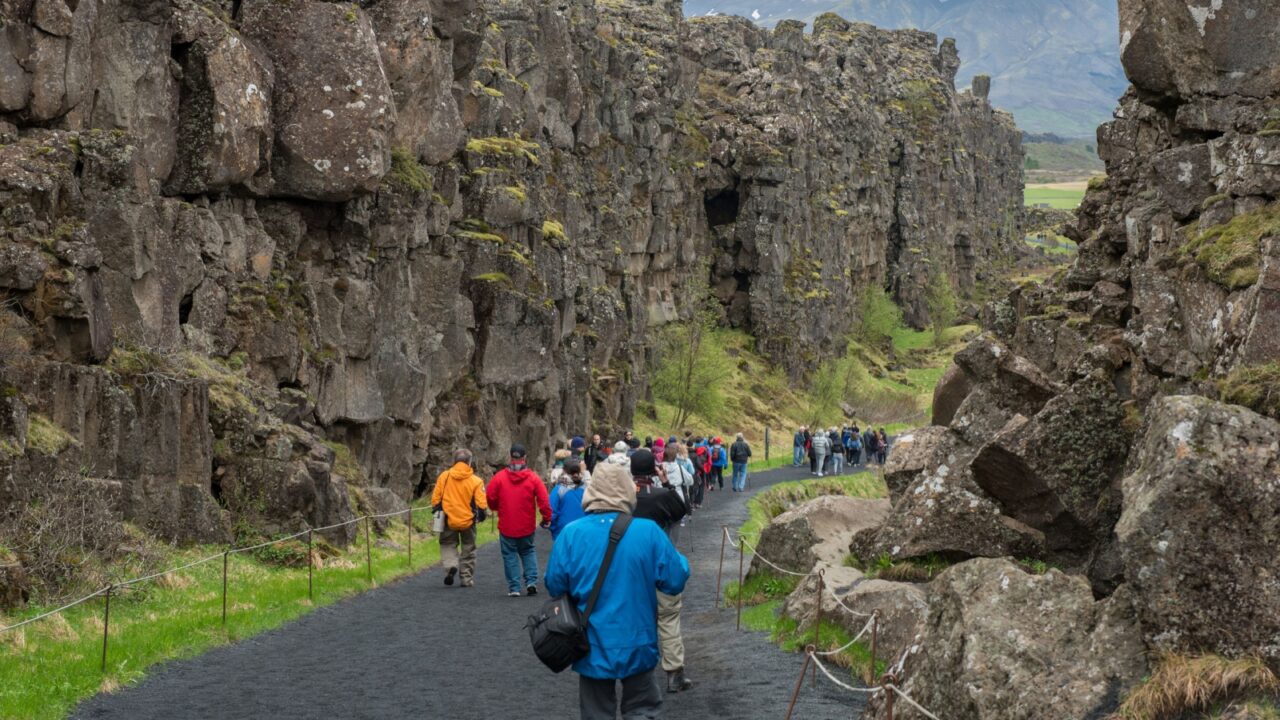 THINGVELLIR, ICELAND - MAY 20, 2019: Crowd of tourists visiting Thingvellir National Park a site of historical, cultural, and geological significance
