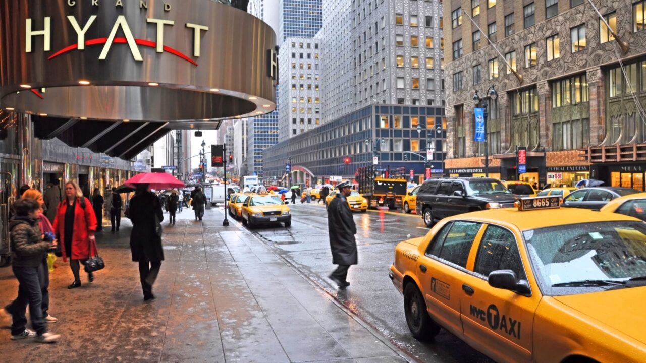 New York, USA - April 06, 2014: Waiting for a taxi outside the Grand Hyatt hotel on East 42nd Street on a wet morning.