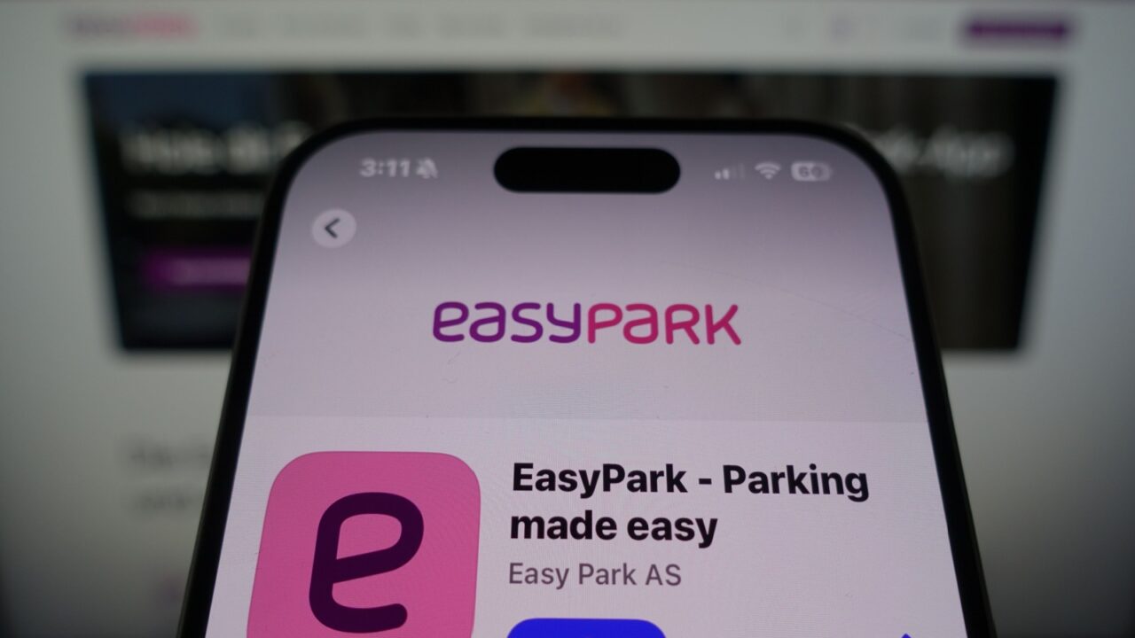 Kiel, SH, Germany March 27 2025: EasyPark by Easy Park AS in the App Store on smartphone screen with company website in background showcasing service offerings.