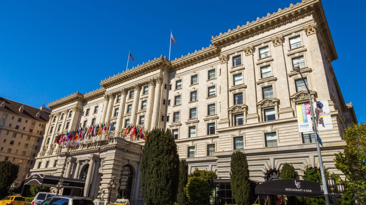 San Francisco, California, USA- 07 June 2015: Yellow taxi on Tony Bennett Way. Hotel Fairmont in the background.