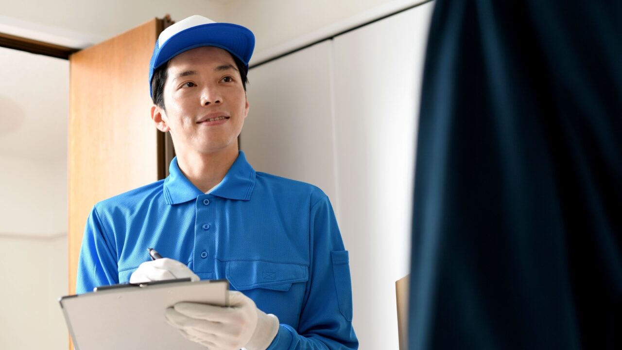 A male worker and a young male customer having a conversation in the room