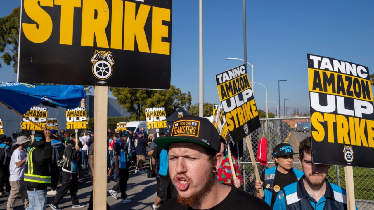 Amazon workers picket outside the gates of an Amazon fulfillment center during a strike as Teamsters seek a nationwide labor contract Friday, Dec. 20, 2024, in City of Industry, California.